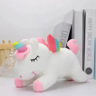 Peluche Licorne blanc sur une table vue sous un autre angle
