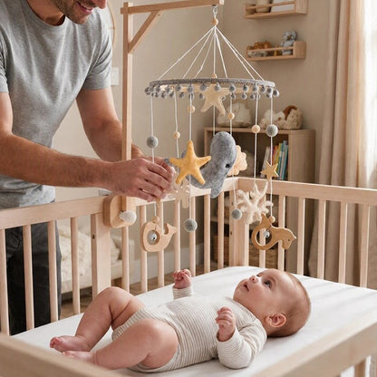 papa installant mobile bébé océan chambre