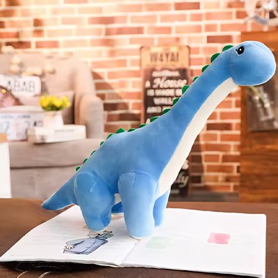 Peluche dinosaure bleu sur une table