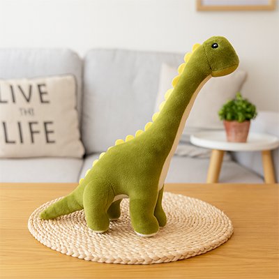 Peluche dinosaure vert sur une table