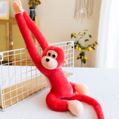 Peluche singe rouge sr une table