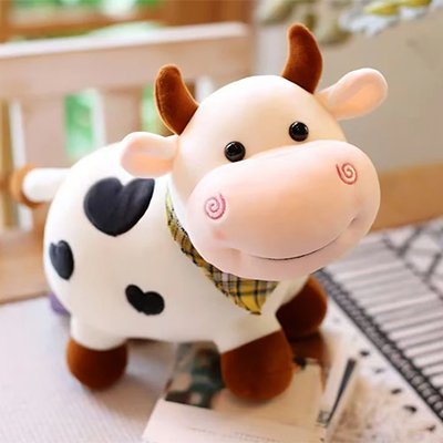 Peluche vache blanche sur une table