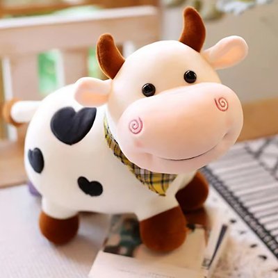 Peluche vache blanc sur une table